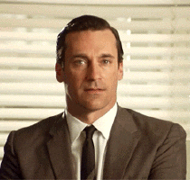 Don Draper from Mad Men winking at you slightly seductively.