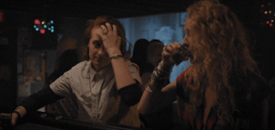 A gif of two strangers flirting in a bar.